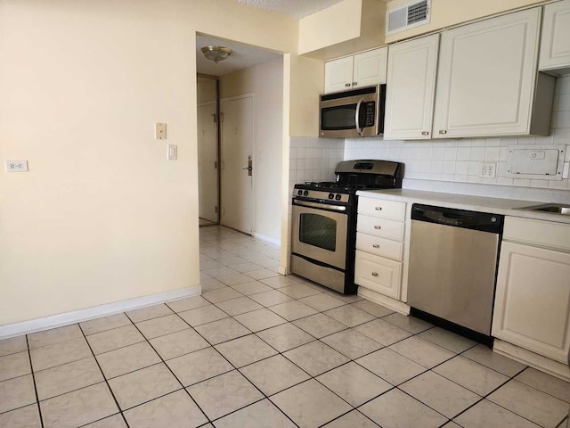 8815 W Golf Rd Unit 6B, Niles, IL 60714 - kitchen featuring stainless steel appliances, light countertops, tasteful backsplash, white cabinets, and light tile patterned floors