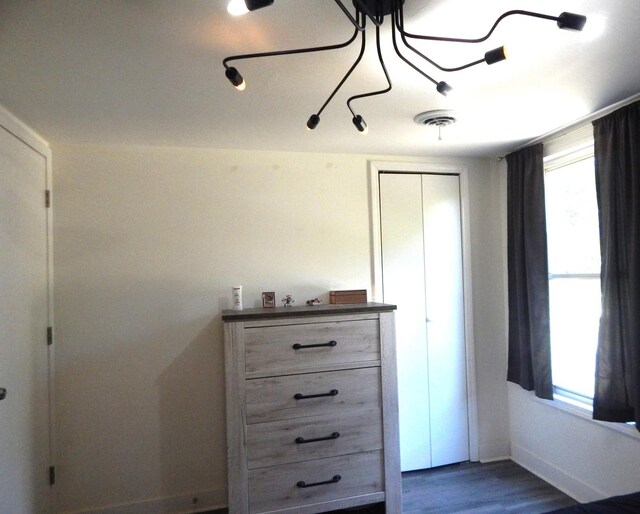 2406 Grape St, Joliet, IL 60435 - bedroom with multiple windows, dark wood-style floors, baseboards, and a closet