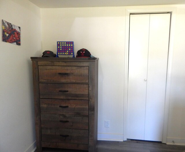2406 Grape St, Joliet, IL 60435 - bedroom featuring dark wood-style flooring, baseboards, and a closet