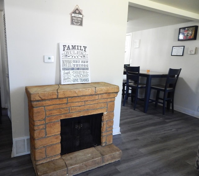 2406 Grape St, Joliet, IL 60435 - detailed view of wood finished floors, a stone fireplace, and baseboards