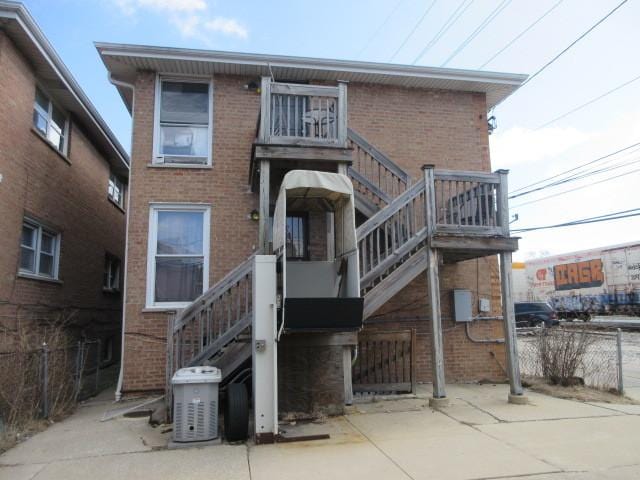 7448 S Maplewood Ave, Chicago, IL 60629 - rear view of house featuring stairway, brick siding, and central AC