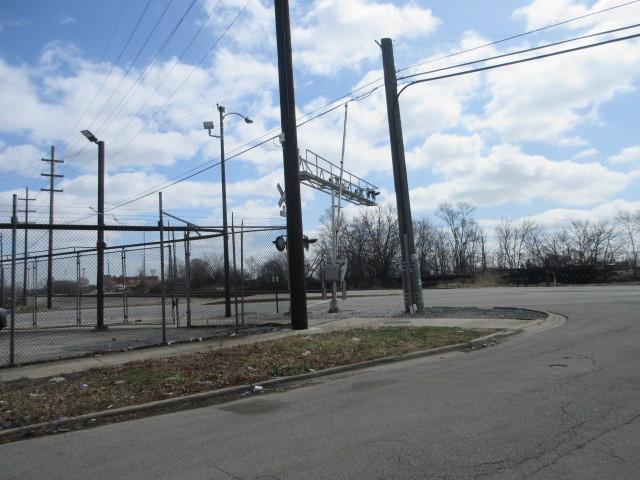 7448 S Maplewood Ave, Chicago, IL 60629 - view of asphalt road with curbs and street lighting