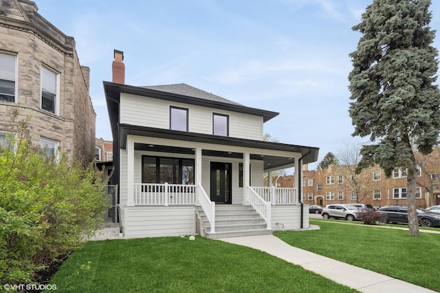 4256 N Keeler Ave, Chicago, IL 60641 - american foursquare style home with a front lawn, a porch, and a chimney