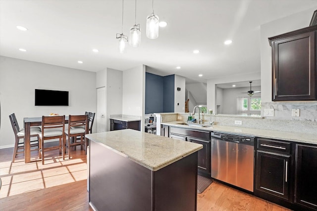 525 Plaza Pl, Aurora, IL 60504 - kitchen featuring stainless steel dishwasher, a sink, light wood-type flooring, ceiling fan, and a peninsula