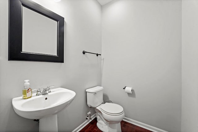 525 Plaza Pl, Aurora, IL 60504 - half bath featuring baseboards, toilet, wood finished floors, and a sink