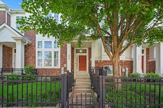 525 Plaza Pl, Aurora, IL 60504 - view of front of property with brick siding, a fenced front yard, and a gate