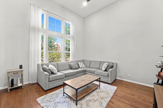 525 Plaza Pl, Aurora, IL 60504 - living area with wood finished floors, baseboards, a towering ceiling, and ceiling fan