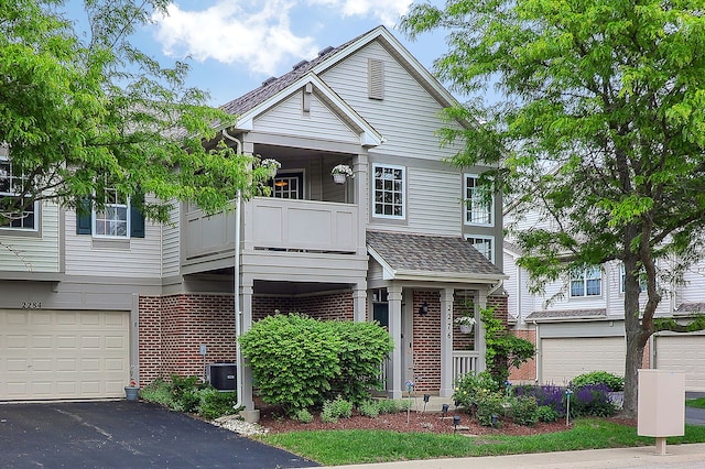 2276 Vanderbilt Dr Unit 2276, Geneva, IL 60134 - townhome / multi-family property with brick siding, a balcony, a garage, and driveway