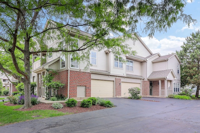 2276 Vanderbilt Dr Unit 2276, Geneva, IL 60134 - view of front facade featuring brick siding, driveway, and a garage