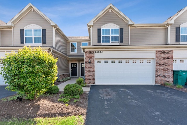 15123 W Quincy Cir, Manhattan, IL 60442 - view of front facade featuring a garage, driveway, and brick siding