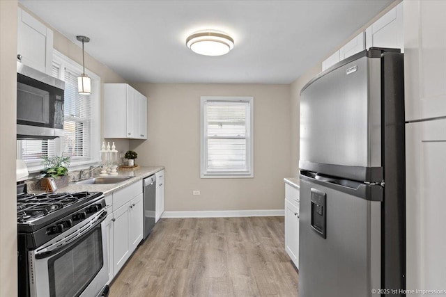 3231 W 99th St, Evergreen Park, IL 60805 - kitchen with appliances with stainless steel finishes, a sink, white cabinets, and light wood finished floors