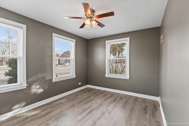 3231 W 99th St, Evergreen Park, IL 60805 - spare room featuring wood finished floors, baseboards, and ceiling fan
