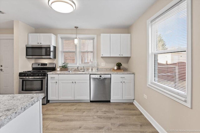 3231 W 99th St, Evergreen Park, IL 60805 - kitchen featuring appliances with stainless steel finishes, a sink, white cabinetry, and healthy amount of natural light