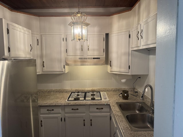 509 N Quincy St, Clinton, IL 61727 - kitchen with under cabinet range hood, freestanding refrigerator, a sink, wooden ceiling with exposed beams, and white cabinetry