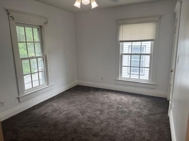 509 N Quincy St, Clinton, IL 61727 - empty room with dark carpet, baseboards, and ceiling fan
