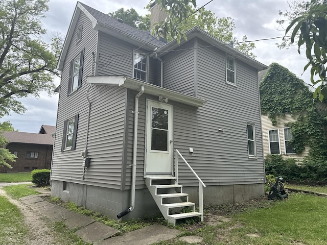 509 N Quincy St, Clinton, IL 61727 - back of house featuring entry steps and a chimney