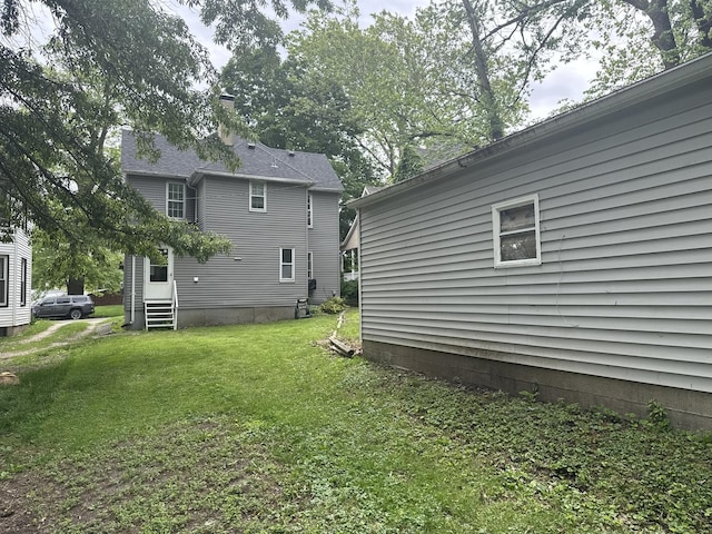 509 N Quincy St, Clinton, IL 61727 - rear view of house with a yard and entry steps