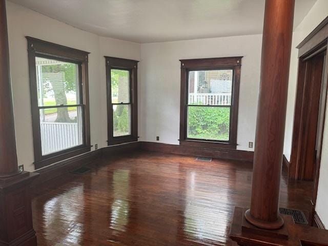 509 N Quincy St, Clinton, IL 61727 - spare room with decorative columns and wood finished floors