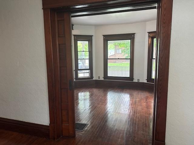 509 N Quincy St, Clinton, IL 61727 - unfurnished room featuring hardwood / wood-style floors, a textured wall, and baseboards