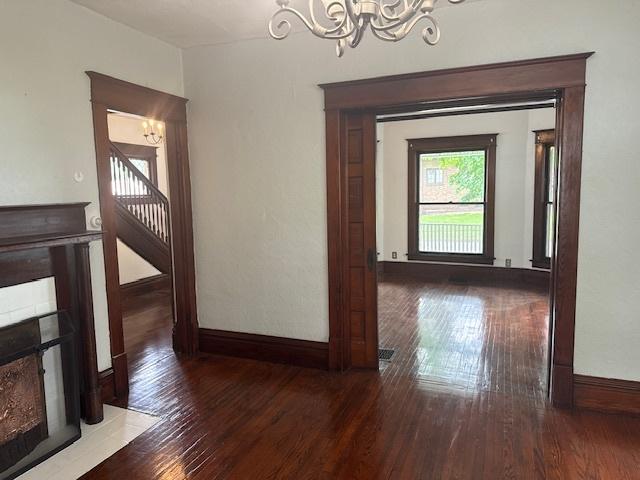 509 N Quincy St, Clinton, IL 61727 - hall featuring a chandelier, wood finished floors, and baseboards