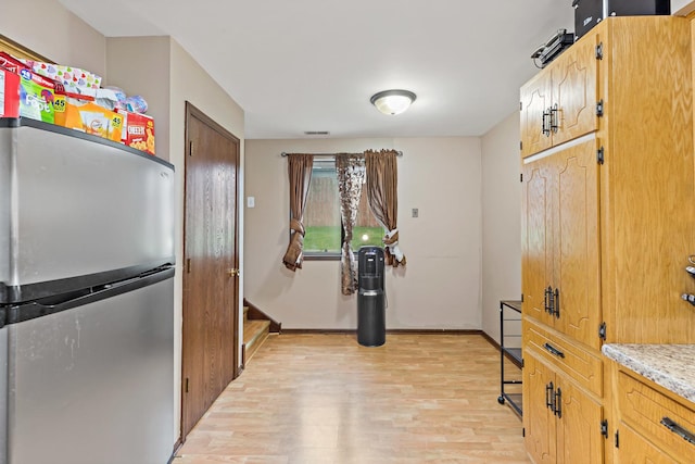 8517 Steven Pl Unit 4, Tinley Park, IL 60477 - kitchen with freestanding refrigerator, light wood-type flooring, light countertops, and baseboards