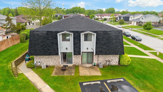 8517 Steven Pl Unit 4, Tinley Park, IL 60477 - view of front of house featuring a shingled roof, a residential view, uncovered parking, stone siding, and a patio