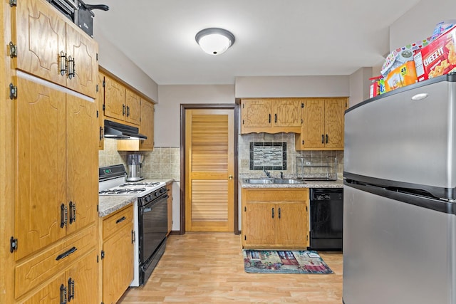 8517 Steven Pl Unit 4, Tinley Park, IL 60477 - kitchen with freestanding refrigerator, dishwasher, gas range, under cabinet range hood, and light wood-style floors
