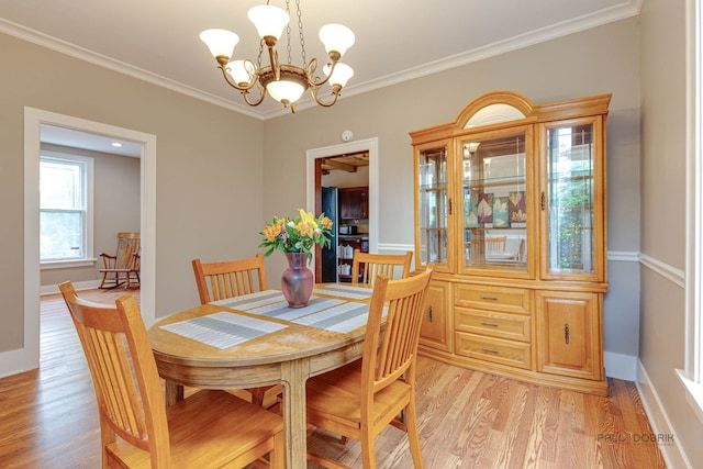 71 S Chestnut St, Aurora, IL 60506 - dining area featuring a chandelier, light wood-style flooring, ornamental molding, and baseboards