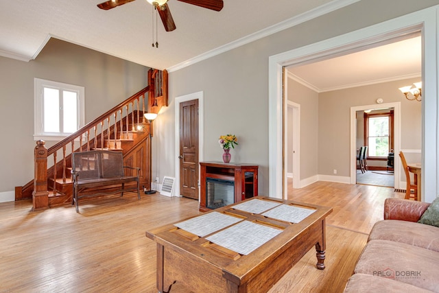 71 S Chestnut St, Aurora, IL 60506 - living area featuring ornamental molding, healthy amount of natural light, stairway, a ceiling fan, and light wood finished floors