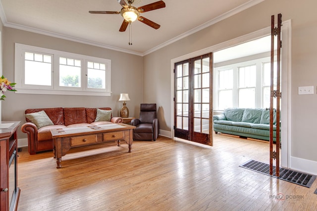 71 S Chestnut St, Aurora, IL 60506 - living area with crown molding, a ceiling fan, light wood-type flooring, baseboards, and french doors