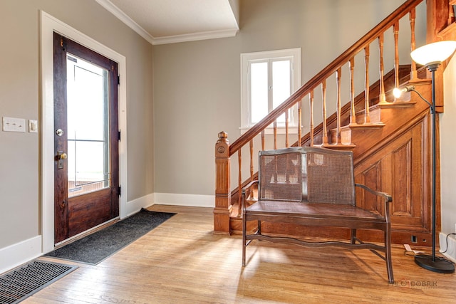 71 S Chestnut St, Aurora, IL 60506 - entrance foyer featuring light wood finished floors, healthy amount of natural light, stairs, crown molding, and baseboards