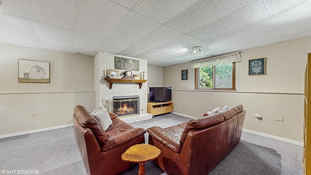 26W029 Hazel Ln, Wheaton, IL 60187 - carpeted living area featuring a drop ceiling and a brick fireplace