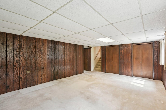 7913 Grant St, Darien, IL 60561 - finished below grade area with stairway, wooden walls, a drop ceiling, and carpet
