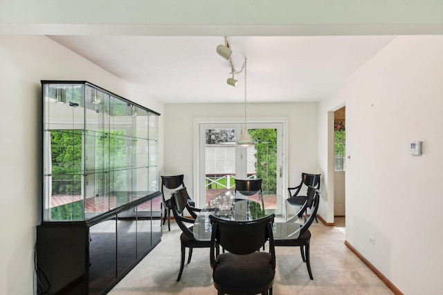 7913 Grant St, Darien, IL 60561 - dining area with light colored carpet, baseboards, and track lighting