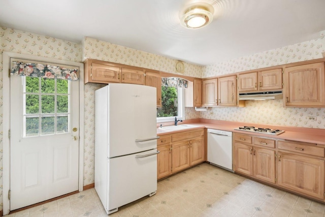 7913 Grant St, Darien, IL 60561 - kitchen featuring white appliances, wallpapered walls, under cabinet range hood, a sink, and light countertops