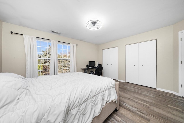 410 Cobblestone Ct, Oswego, IL 60543 - bedroom featuring wood finished floors, multiple closets, and baseboards