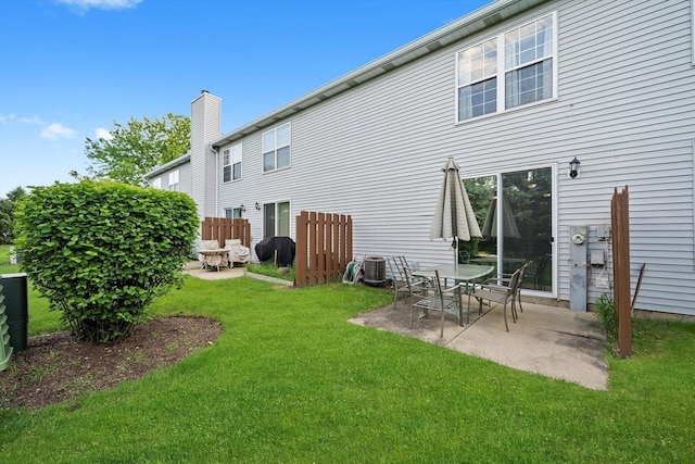 410 Cobblestone Ct, Oswego, IL 60543 - rear view of property with a patio area, a lawn, and a chimney