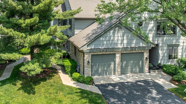 1140 Bristlecone Ct Unit 1140, Darien, IL 60561 - view of front facade featuring concrete driveway, a garage, stone siding, and roof with shingles