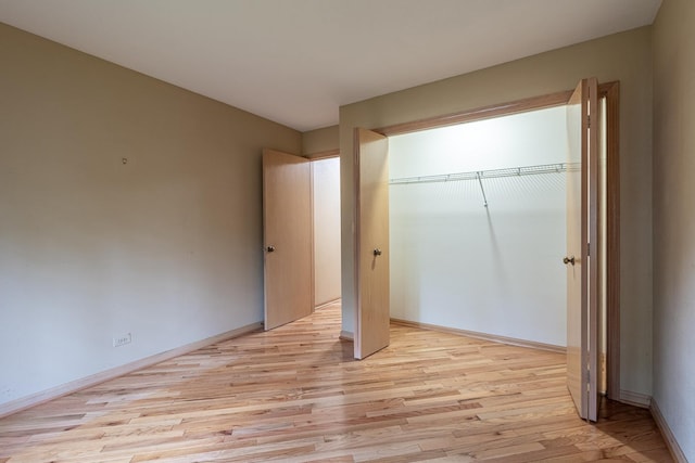 1140 Bristlecone Ct Unit 1140, Darien, IL 60561 - unfurnished bedroom with light wood-style floors, a closet, and baseboards