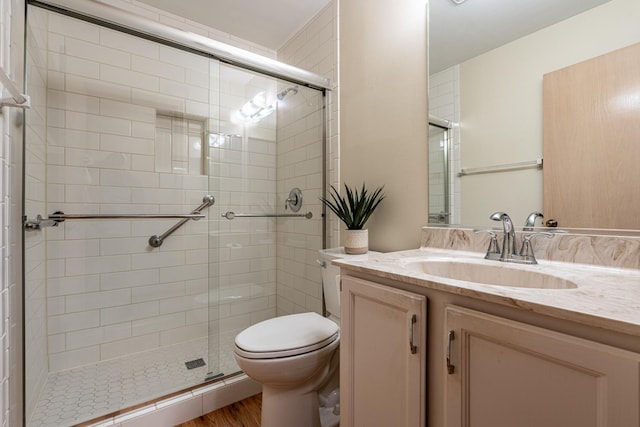 1140 Bristlecone Ct Unit 1140, Darien, IL 60561 - bathroom with toilet, a stall shower, vanity, and wood finished floors