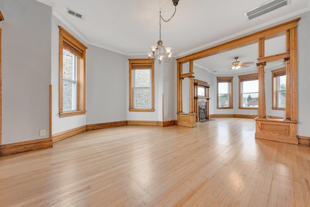 2533 N Kimball Ave, Chicago, IL 60647 - unfurnished living room with ornamental molding, light wood-style flooring, baseboards, and healthy amount of natural light