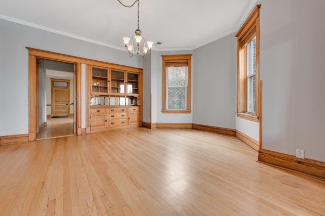 2533 N Kimball Ave, Chicago, IL 60647 - unfurnished room with light wood-style floors, a chandelier, baseboards, and crown molding