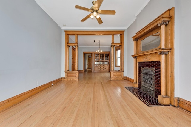 2533 N Kimball Ave, Chicago, IL 60647 - unfurnished living room featuring ornamental molding, wood-type flooring, a fireplace, a chandelier, and a ceiling fan