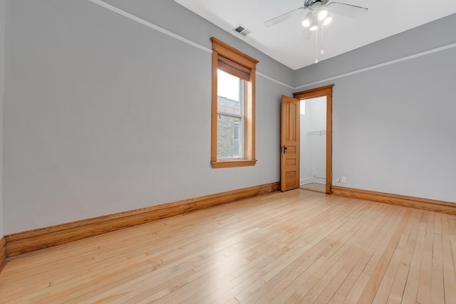 2533 N Kimball Ave, Chicago, IL 60647 - empty room featuring light wood-style floors, baseboards, and a ceiling fan