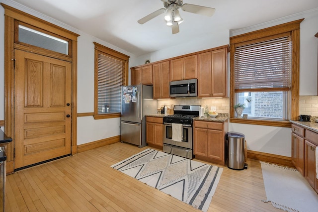 2533 N Kimball Ave, Chicago, IL 60647 - kitchen with appliances with stainless steel finishes, baseboards, and decorative backsplash
