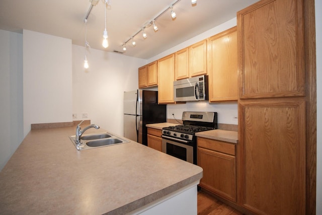 1500 S Halsted St Unit 1B, Chicago, IL 60607 - kitchen featuring stainless steel appliances, a sink, a peninsula, light countertops, and pendant lighting