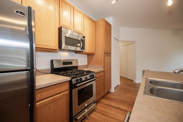 1500 S Halsted St Unit 1B, Chicago, IL 60607 - kitchen with stainless steel appliances, a sink, light countertops, light wood-type flooring, and light brown cabinets