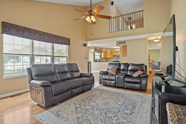 323 Valley Forge Ave, South Elgin, IL 60177 - living area featuring a ceiling fan, light wood finished floors, baseboards, and a high ceiling