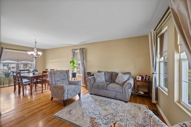 323 Valley Forge Ave, South Elgin, IL 60177 - living room with healthy amount of natural light, a chandelier, and wood finished floors