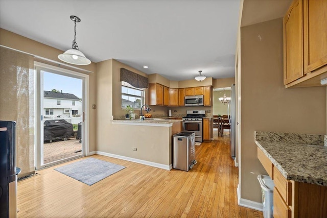 323 Valley Forge Ave, South Elgin, IL 60177 - kitchen with appliances with stainless steel finishes, light wood-style flooring, brown cabinets, and hanging light fixtures